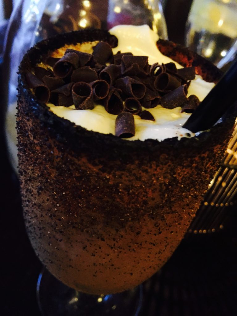 Flaming Hot Coffee a mixture of fire, a dash of sugar, tequila, liqueur and freshly made whip cream sprinkled with chocolate shavings 